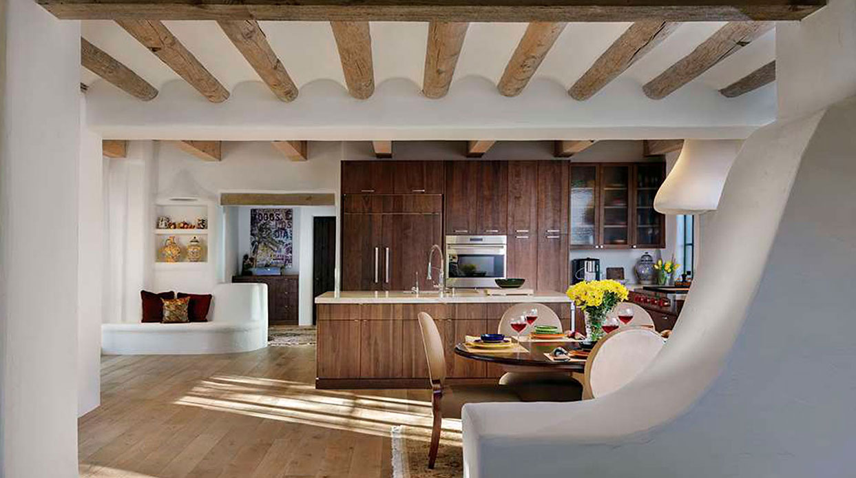 Southwest craftsmanship — plaster hood, stone, vigas